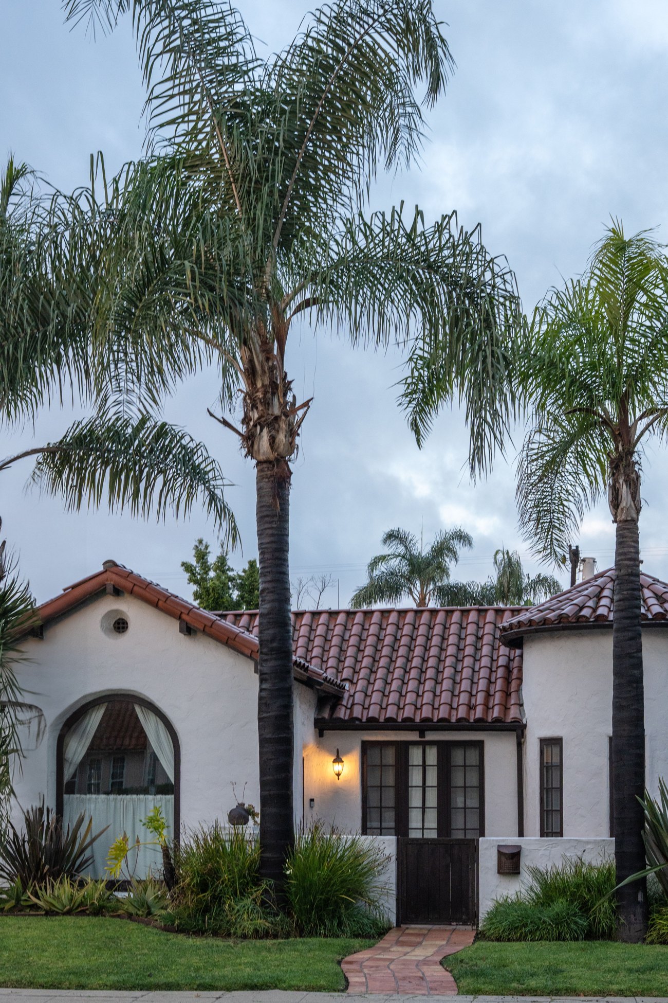 A Spanish-style home with palms in West Hollywood